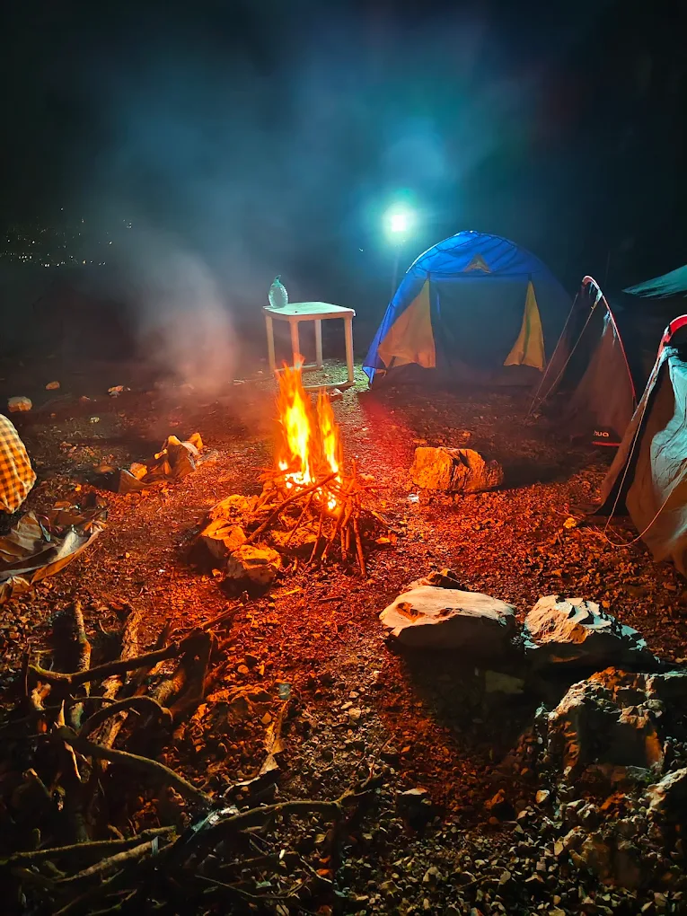 Bonfire at night with tents