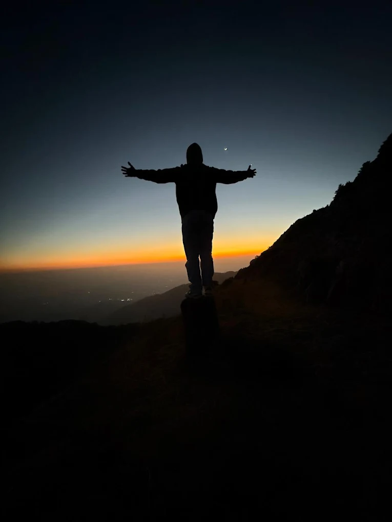Silhouette with open arms at sunset